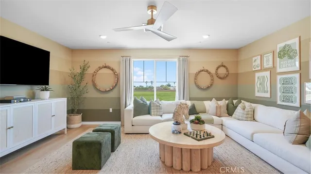 a living room with furniture a rug and a flat screen tv