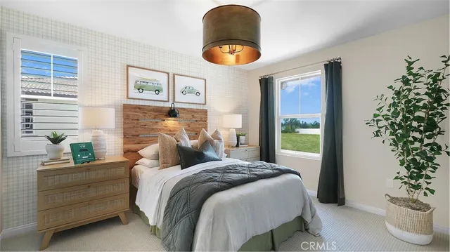 a bedroom with bed and a potted plant