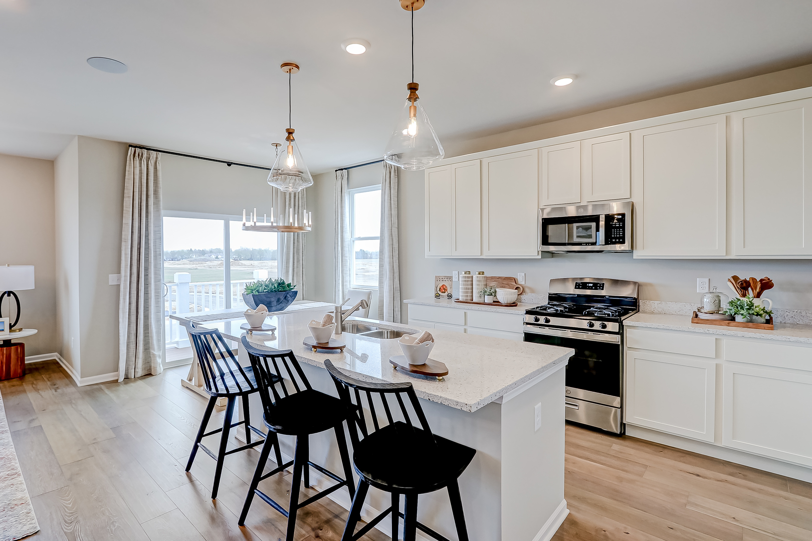 546 Comstock Road South Elgin, IL 60177 - Photo 11 of 31 a kitchen view with stainless steel appliances granite countertop a stove a refrigerator a microwave a dining table and chairs with wooden floor