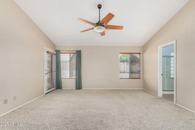 an empty room with closet and windows