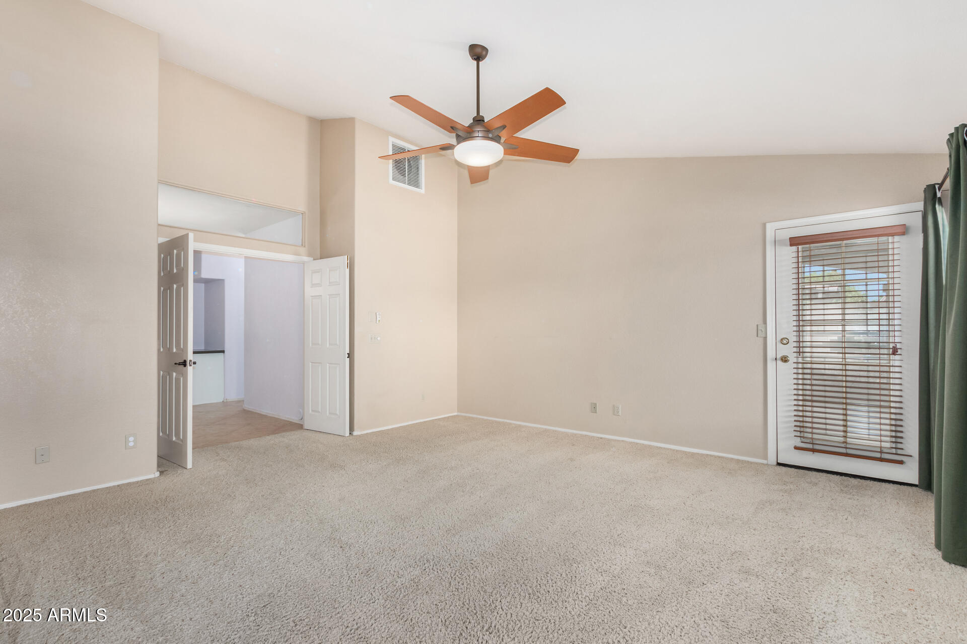 4226 East Rockledge Road Phoenix, AZ 85044 - Photo 17 of 36 a view of an empty room with a ceiling fan