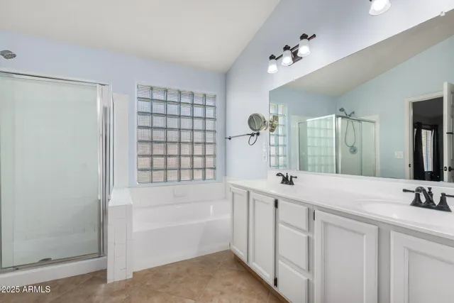 a bathroom with a tub sink and mirror