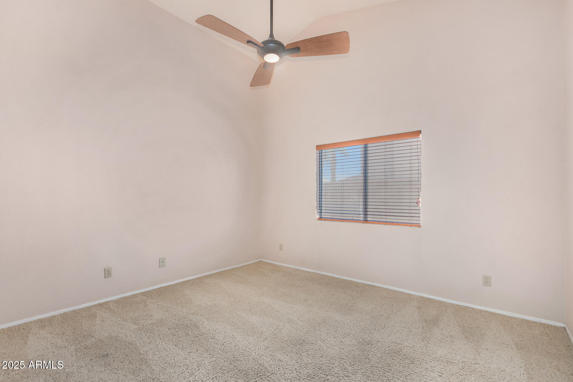 4226 East Rockledge Road Phoenix, AZ 85044 - Photo 22 of 36 an empty room with a window and a fan