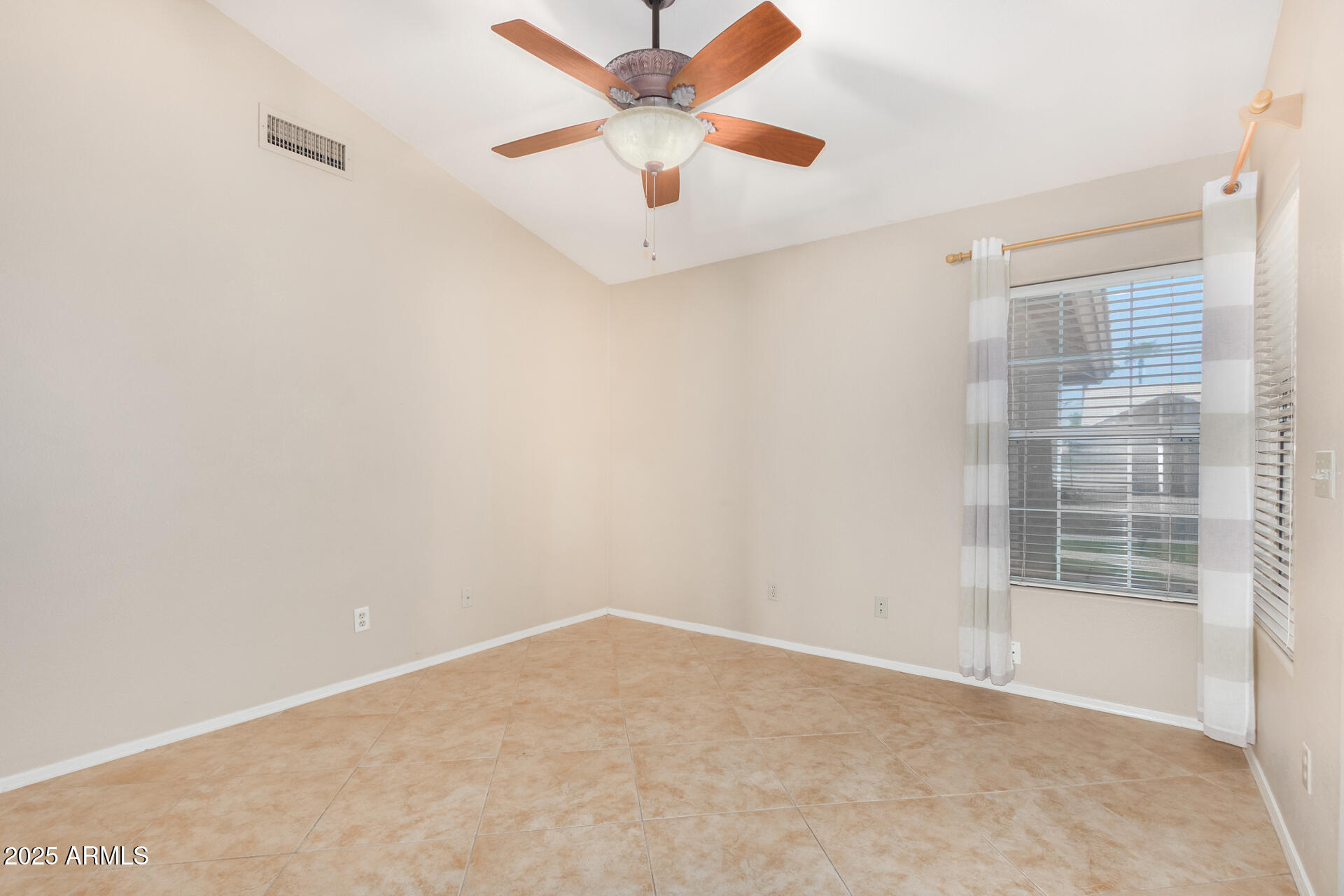 4226 East Rockledge Road Phoenix, AZ 85044 - Photo 24 of 36 an empty room with a window and a ceiling fan