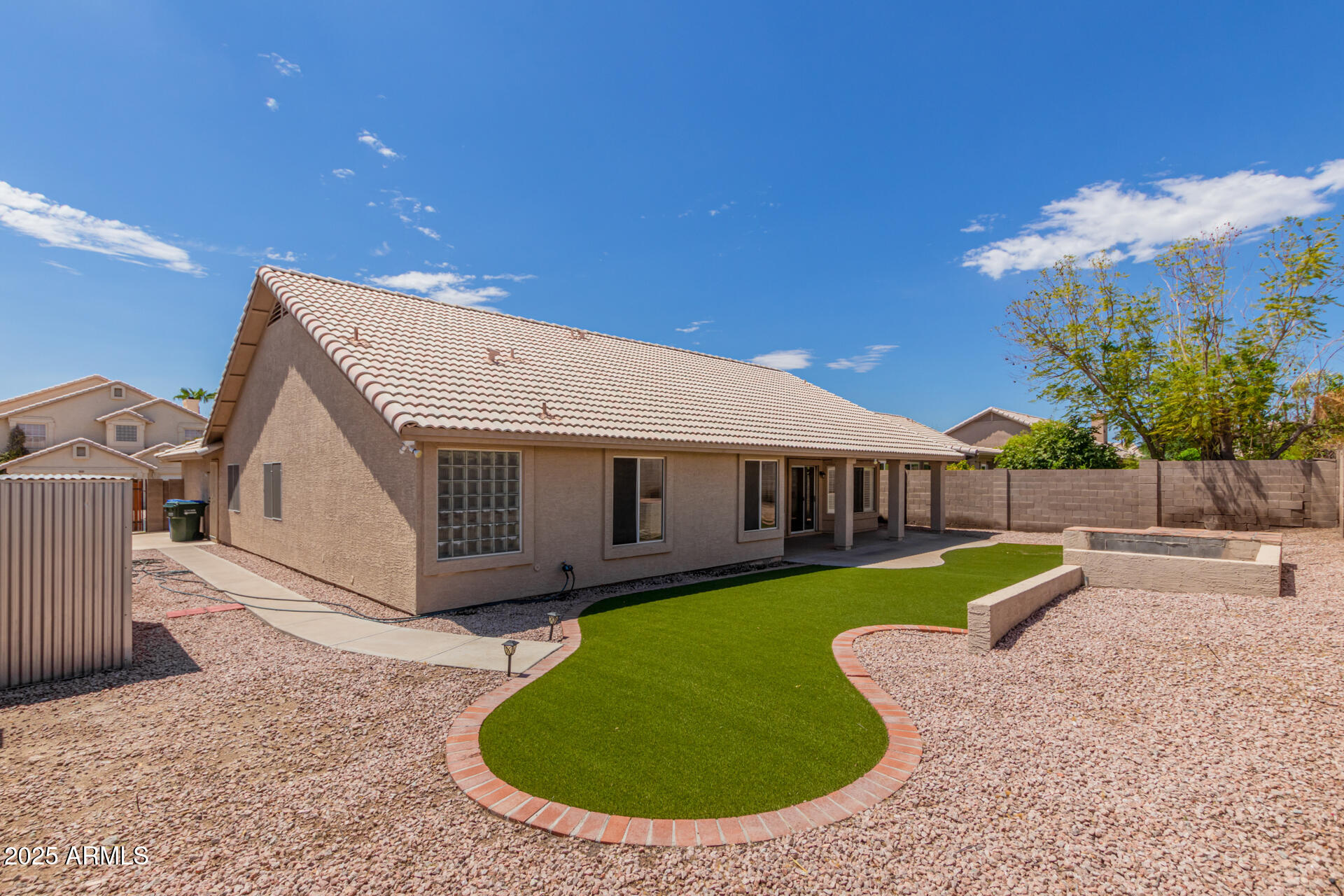 4226 East Rockledge Road Phoenix, AZ 85044 - Photo 31 of 36 a view of a house with a backyard porch and sitting area