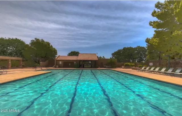a view of a backyard with swimming pool