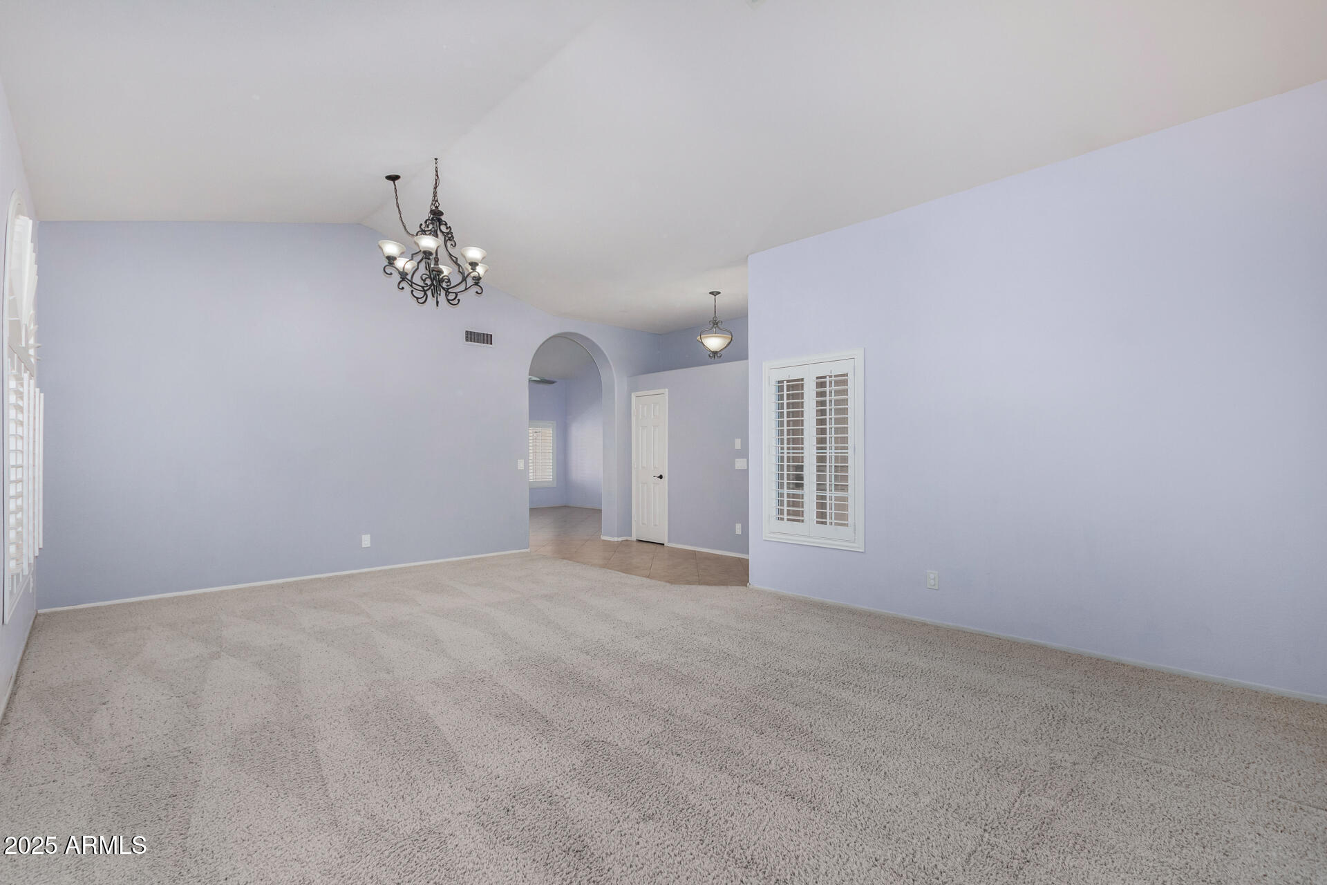 4226 East Rockledge Road Phoenix, AZ 85044 - Photo 4 of 36 a view of an empty room with a chandelier