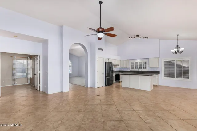 a view of a kitchen with a sink hardwood floor and a ceiling fan