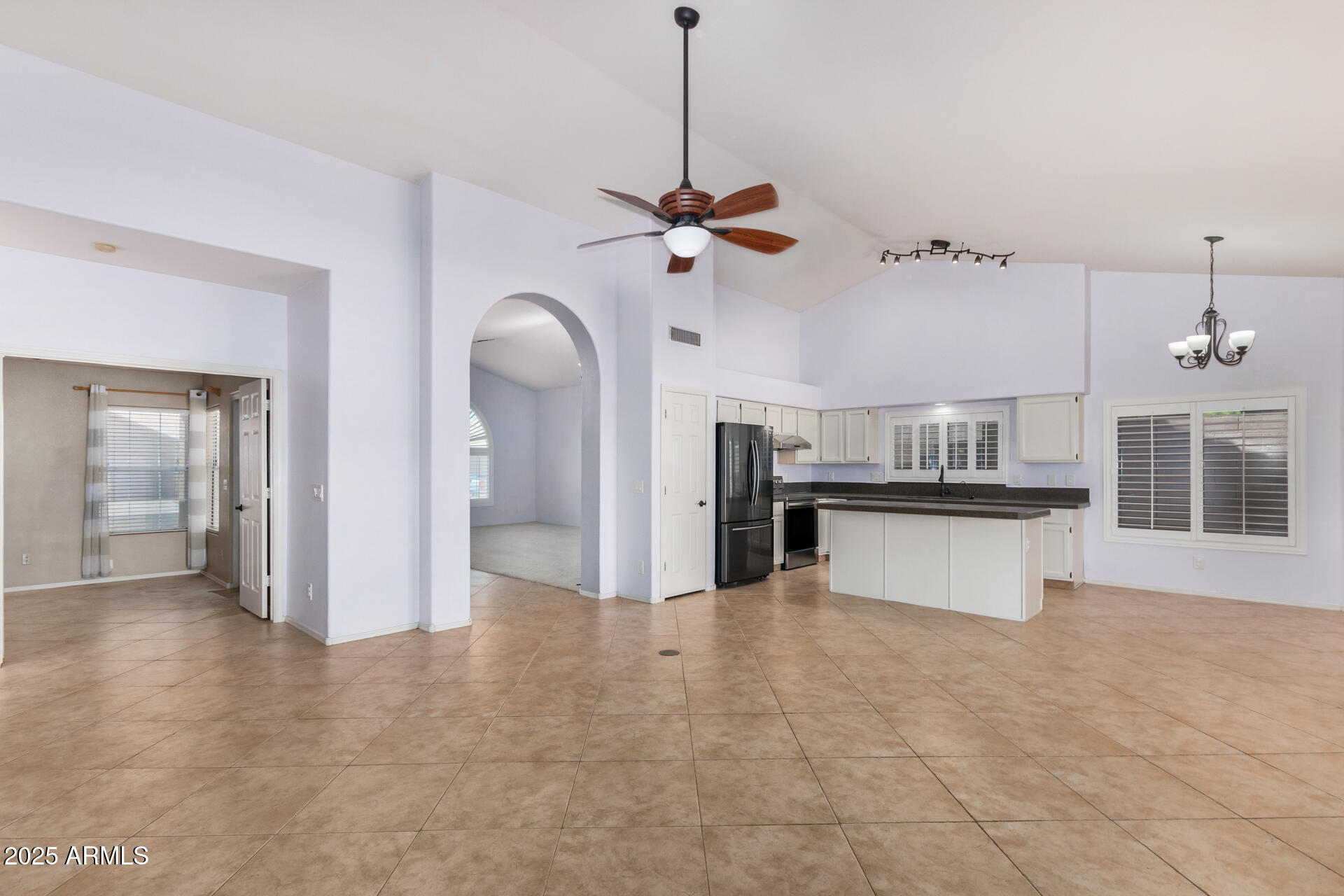 4226 East Rockledge Road Phoenix, AZ 85044 - Photo 8 of 36 a view of a kitchen with a sink hardwood floor and a ceiling fan