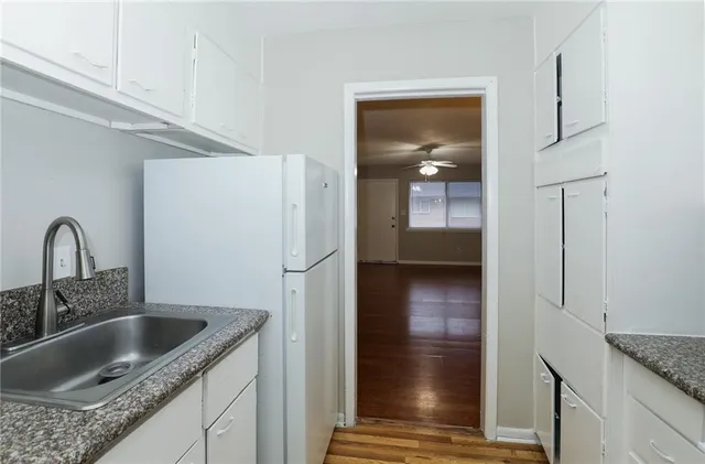 a kitchen with a refrigerator and a sink
