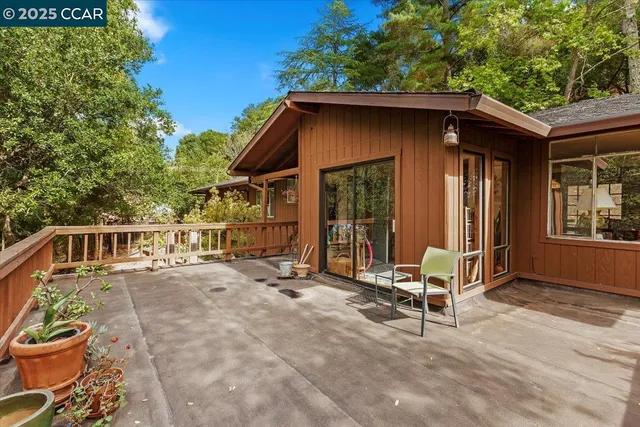 a backyard of a house with table and chairs