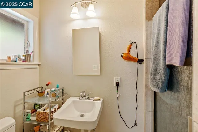 a bathroom with a sink toilet and a mirror