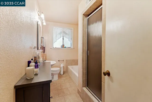 a bathroom with a sink vanity mirror and toilet