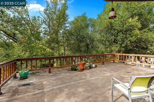 a view of roof deck with two chairs and potted plants