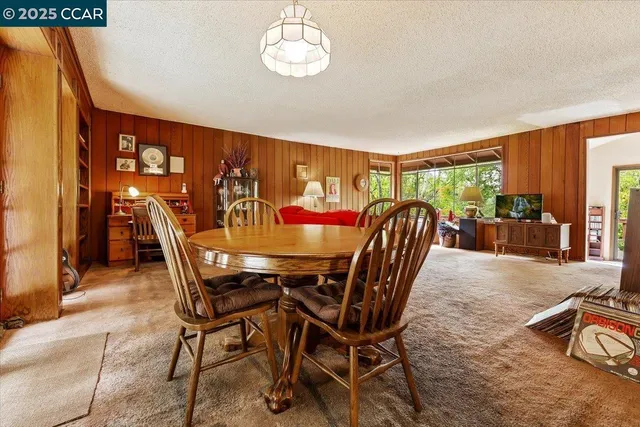 a view of a dining room with furniture window and outside view