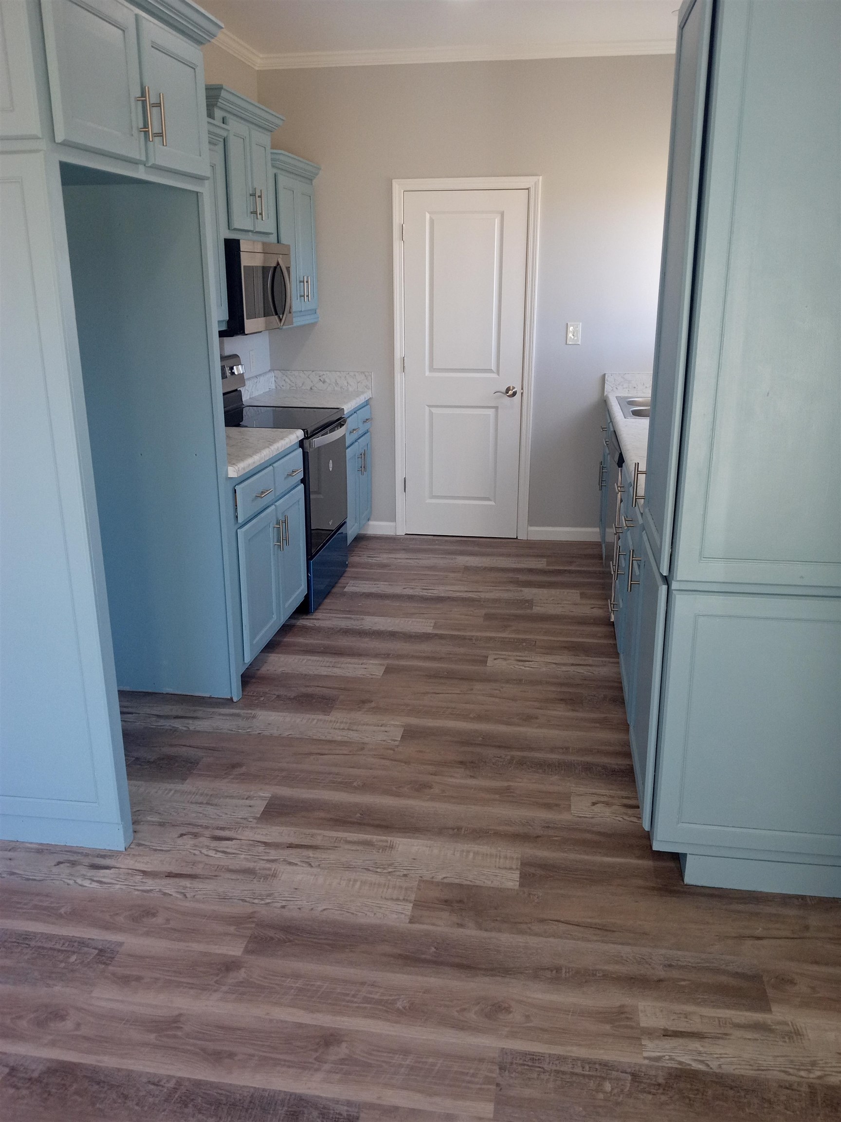 1712 Sanders Road Stanton, TN 38069 - Photo 2 of 10 Kitchen featuring light stone countertops, crown molding, appliances with stainless steel finishes, and dark hardwood / wood-style floors