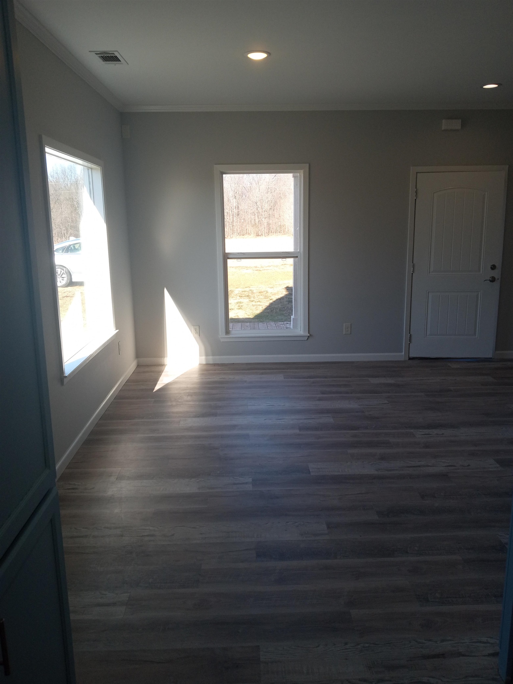 1712 Sanders Road Stanton, TN 38069 - Photo 3 of 10 Spare room with ornamental molding and dark hardwood / wood-style flooring