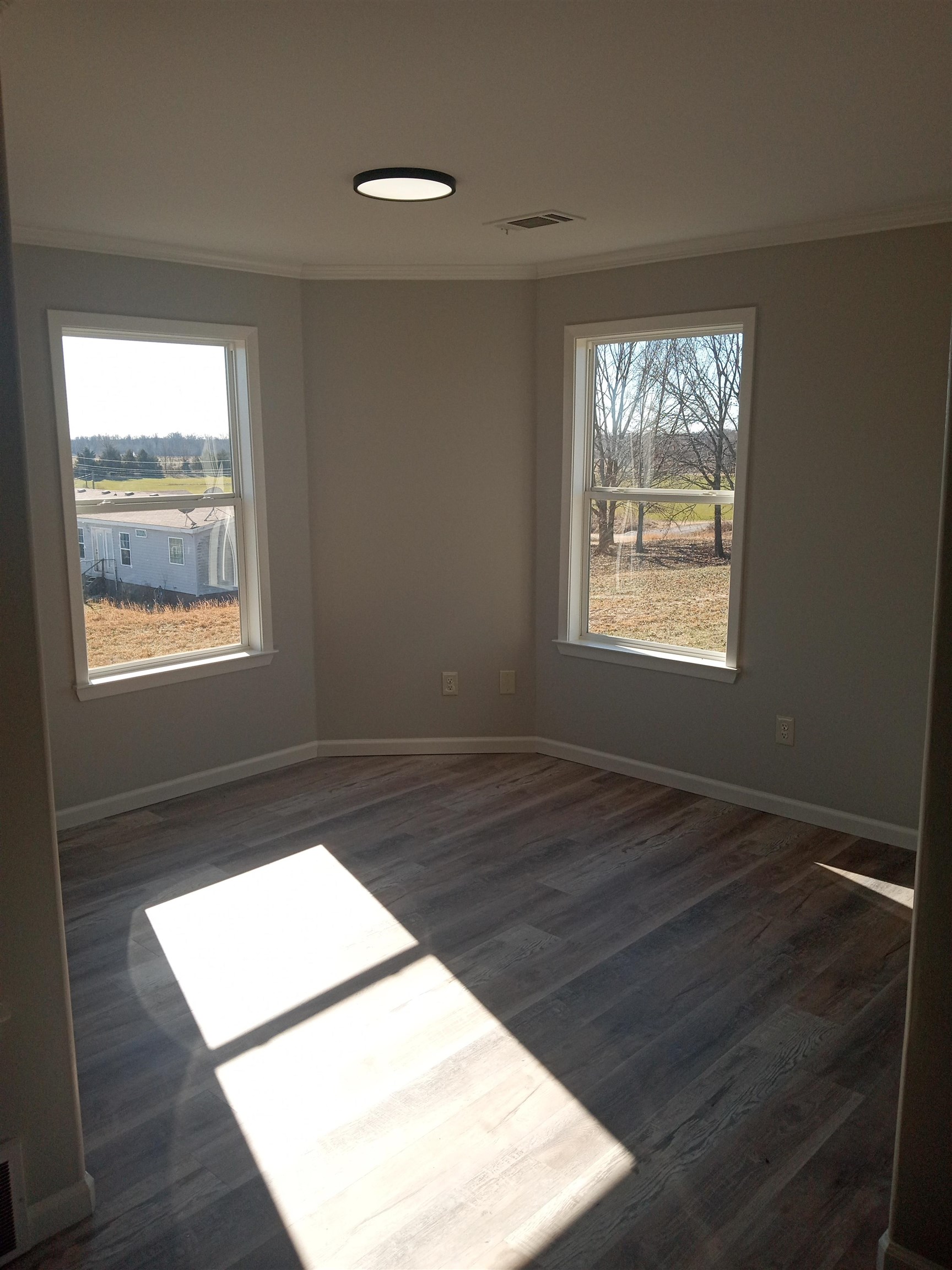 1712 Sanders Road Stanton, TN 38069 - Photo 5 of 10 Empty room with ornamental molding and dark hardwood / wood-style floors