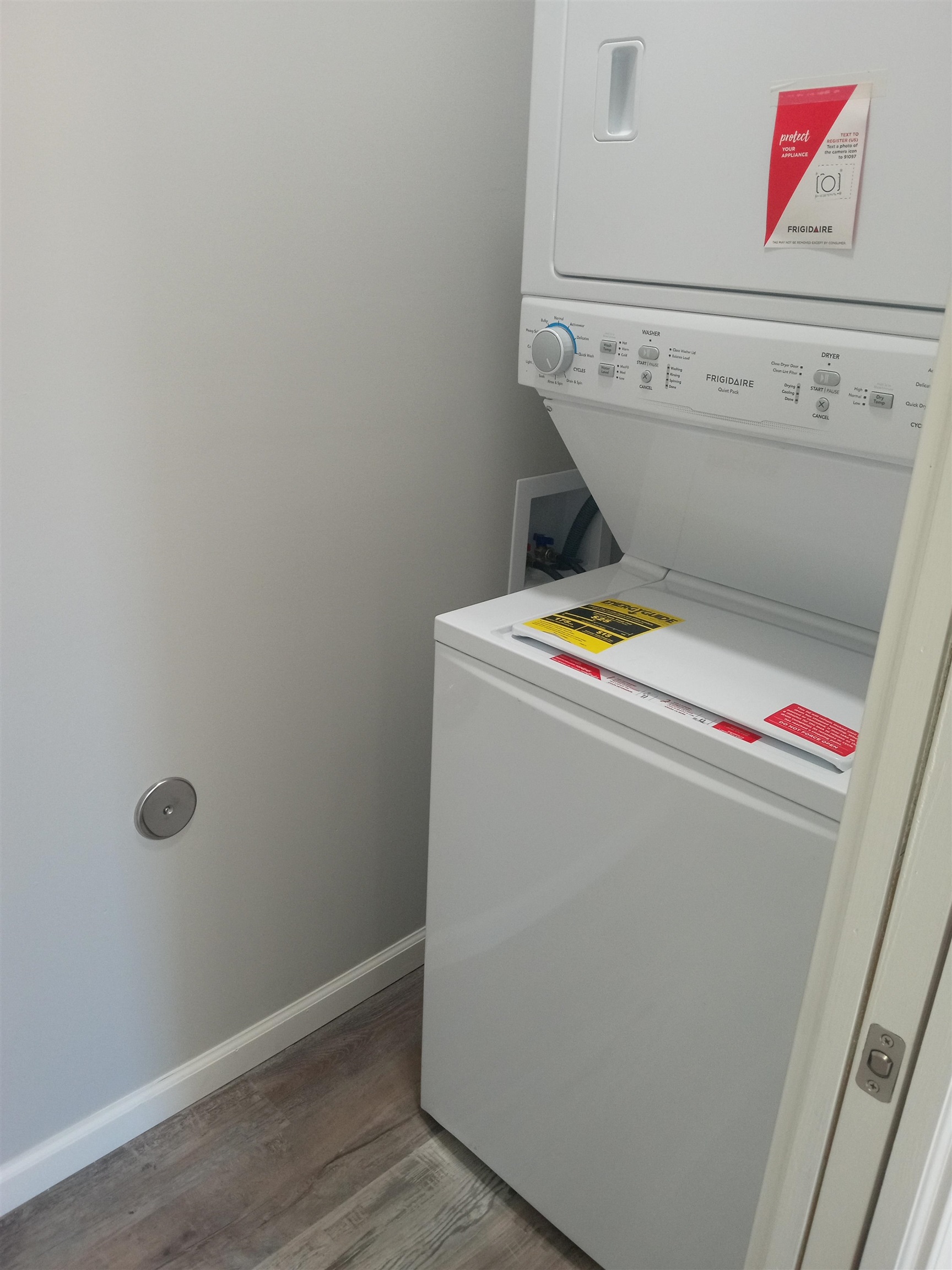 1712 Sanders Road Stanton, TN 38069 - Photo 7 of 10 Washroom with wood-type flooring and stacked washer and clothes dryer