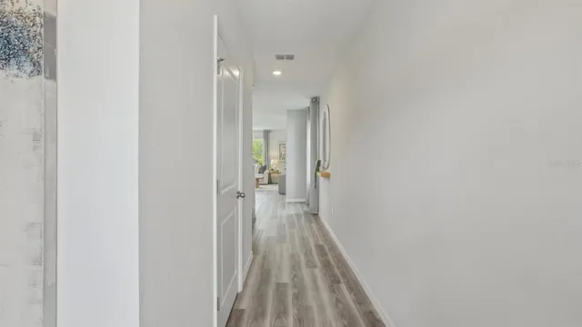 a view of a room with wooden floor