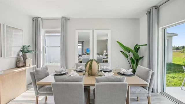 a dining room with furniture and wooden floor
