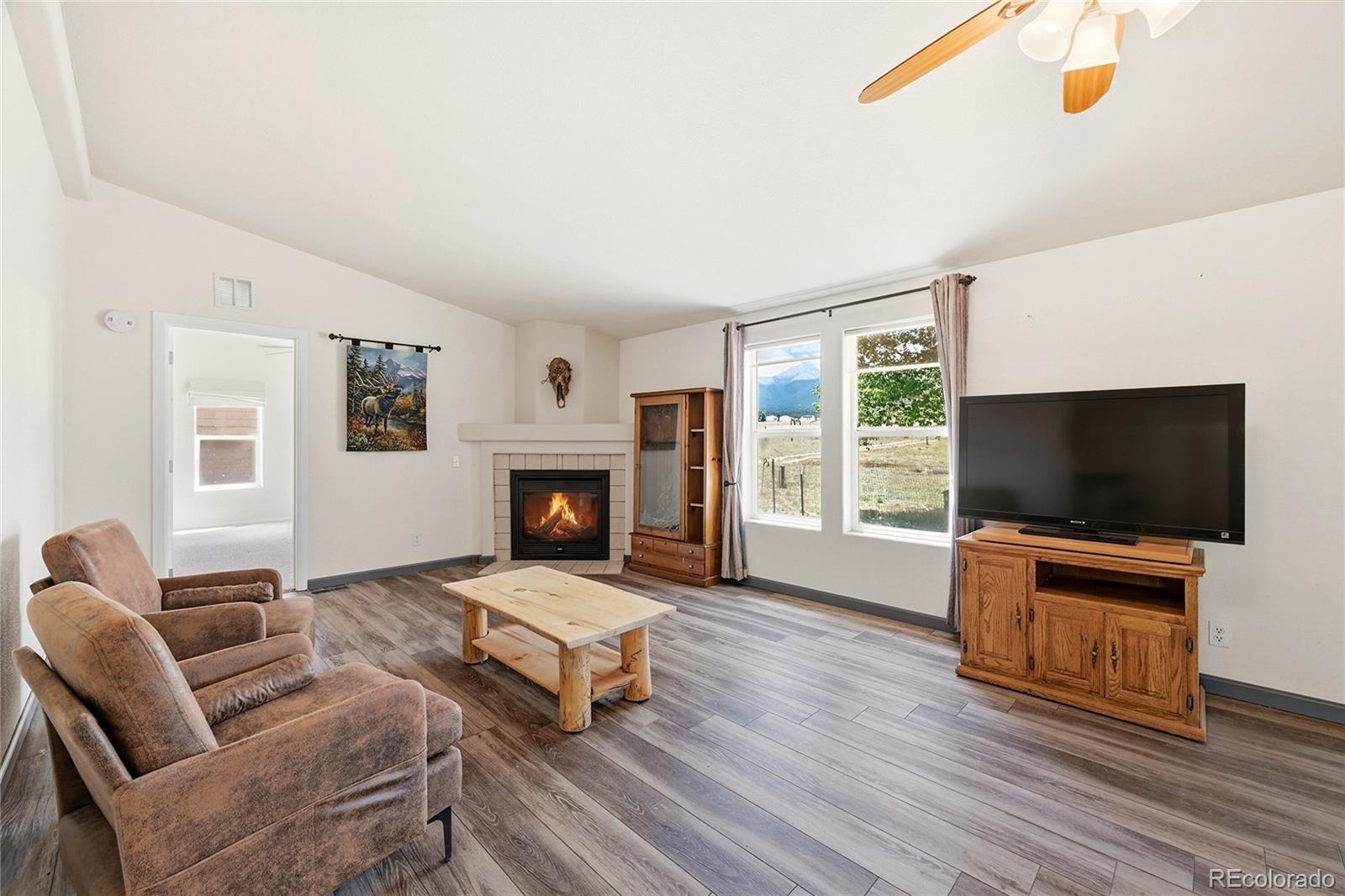 20300 Old Ranch Loop Nathrop, CO 81236 - Photo 11 of 35 a living room with furniture a flat screen tv and a fireplace