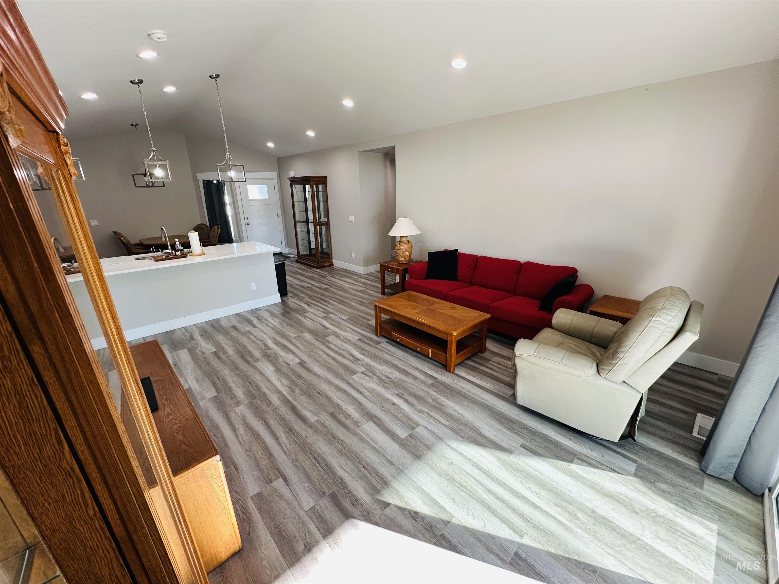 911 Campbell Street Vale, OR 97918 - Photo 7 of 37 Living room with vaulted ceiling, light wood-style flooring, and recessed lighting