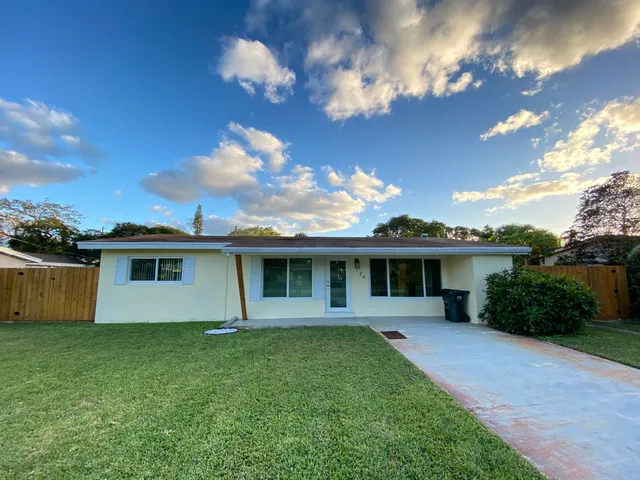 a front view of a house with yard
