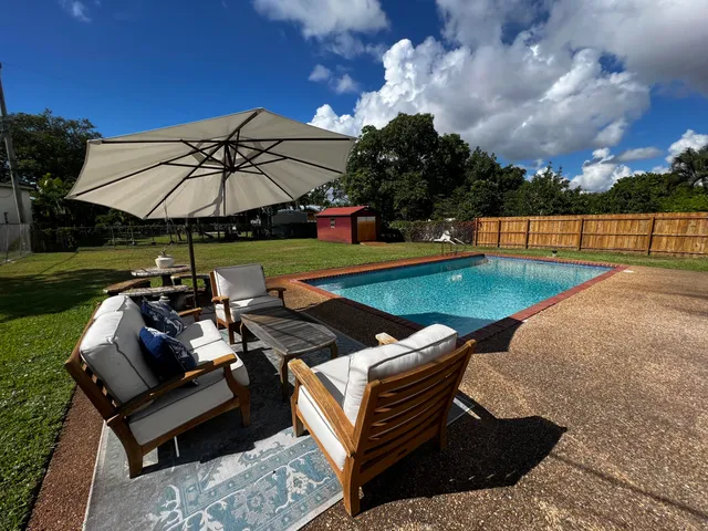 a view of a backyard with sitting area