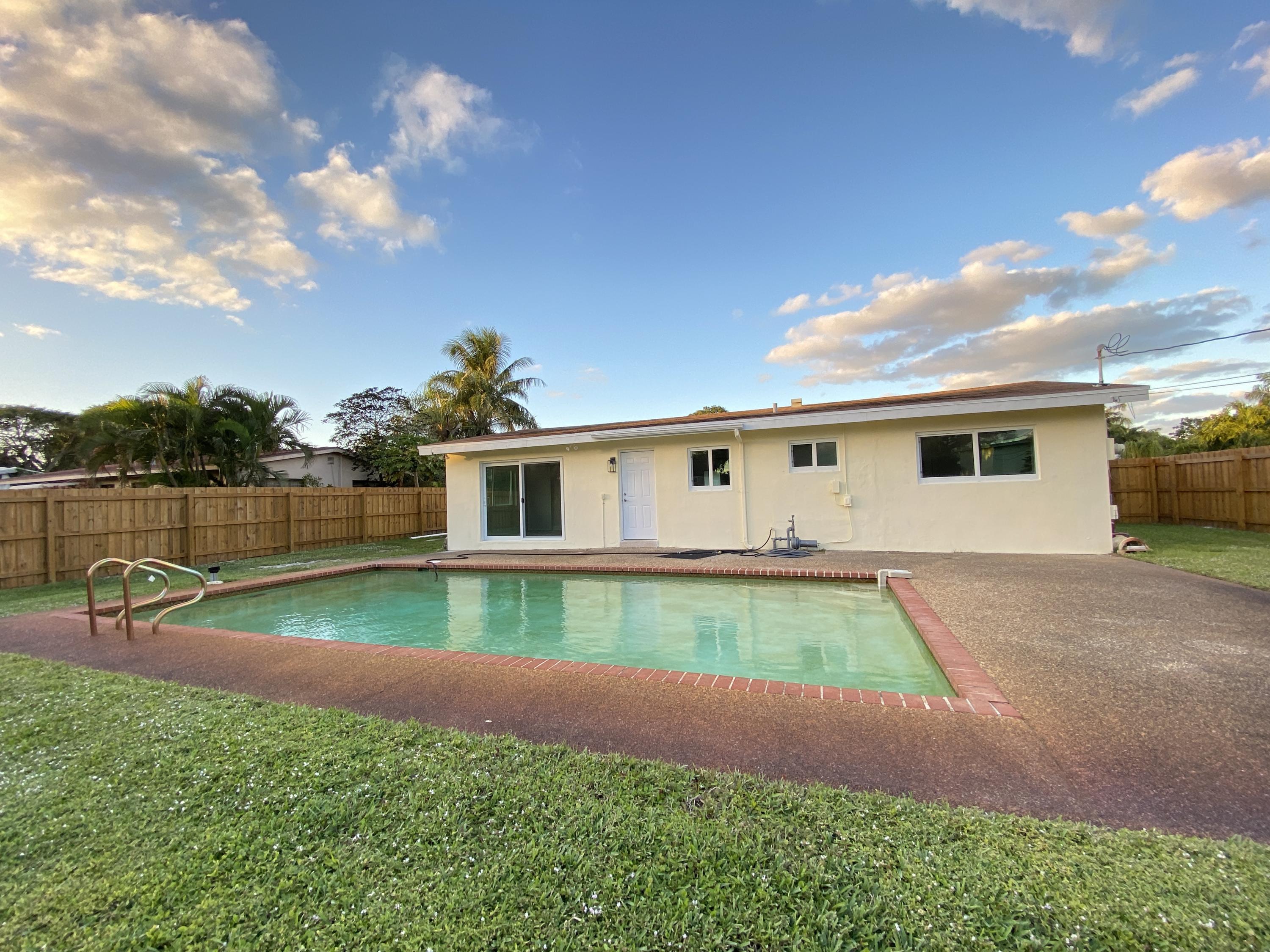 124 Northwest 9th Street Boca Raton, FL 33432 - Photo 12 of 18 a front view of a house with garden