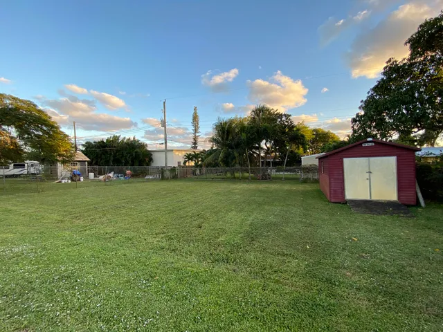 a view of a field of grass and trees