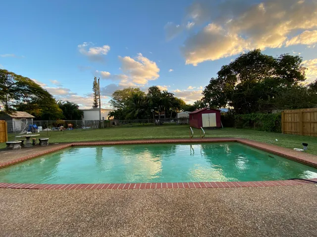 a view of a swimming pool with a yard