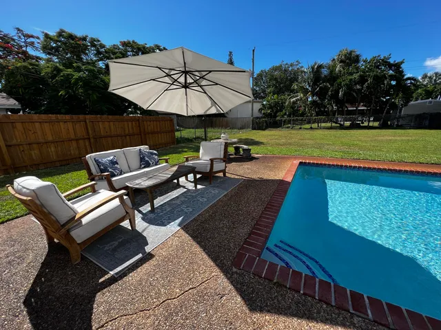 a view of a backyard with sitting area