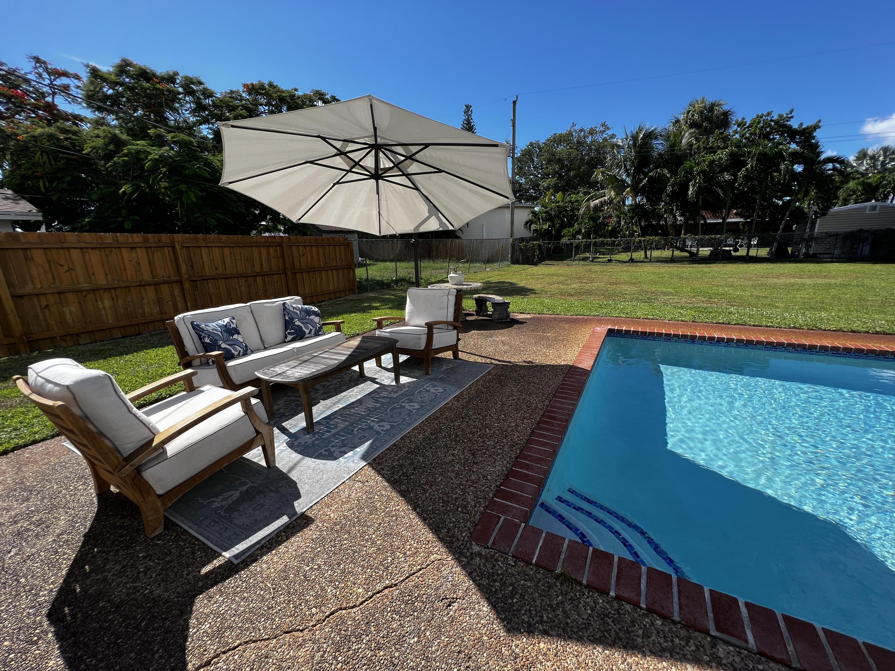 124 Northwest 9th Street Boca Raton, FL 33432 - Photo 16 of 18 a view of a backyard with sitting area