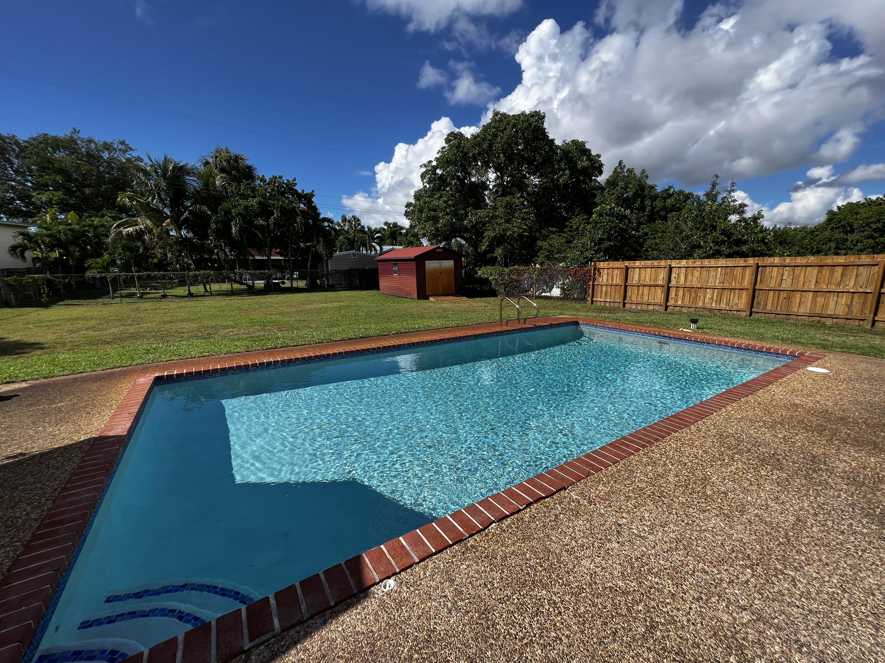 124 Northwest 9th Street Boca Raton, FL 33432 - Photo 17 of 18 a view of a backyard with swimming pool
