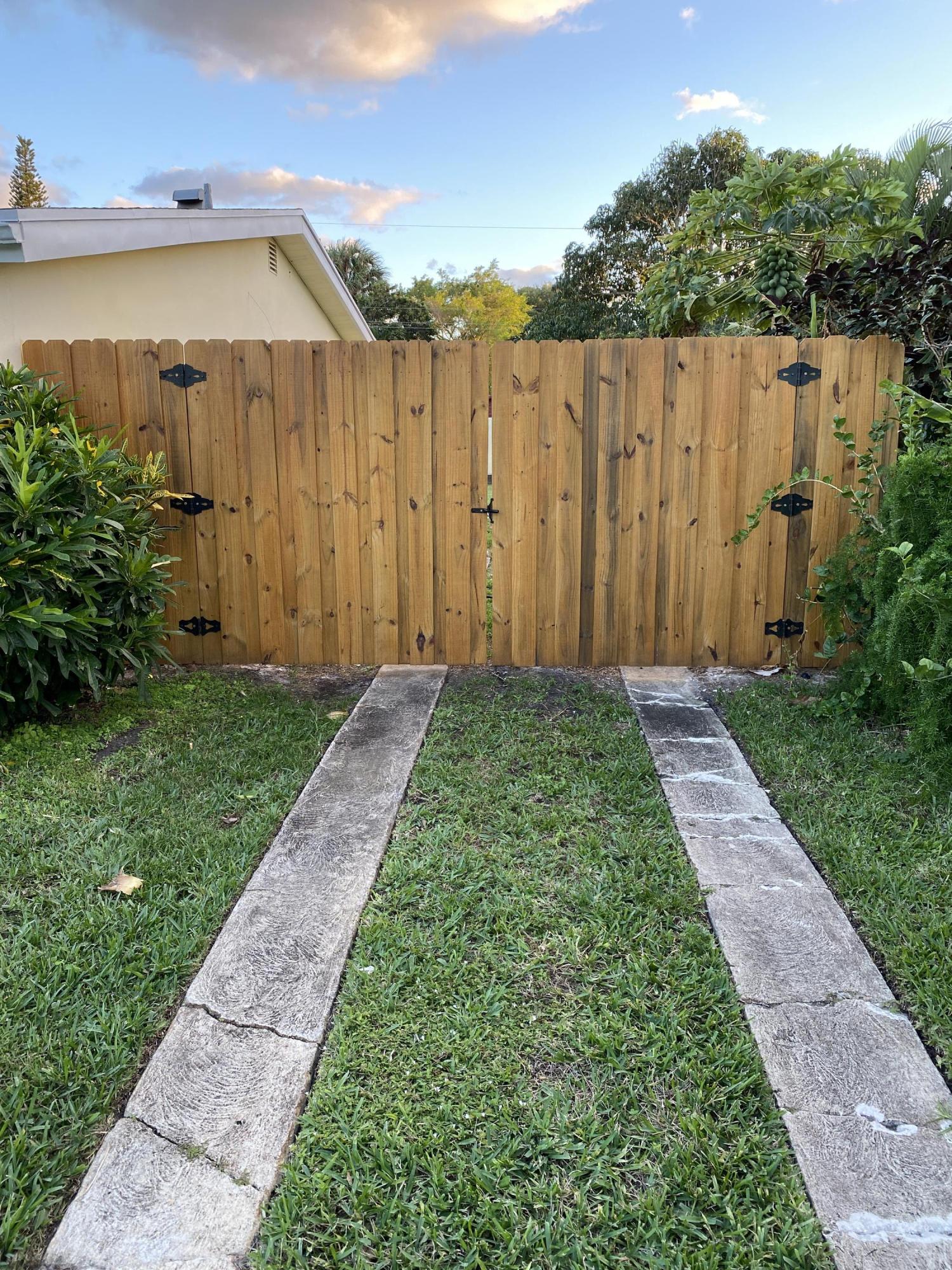 124 Northwest 9th Street Boca Raton, FL 33432 - Photo 18 of 18 a view of a backyard with wooden fence