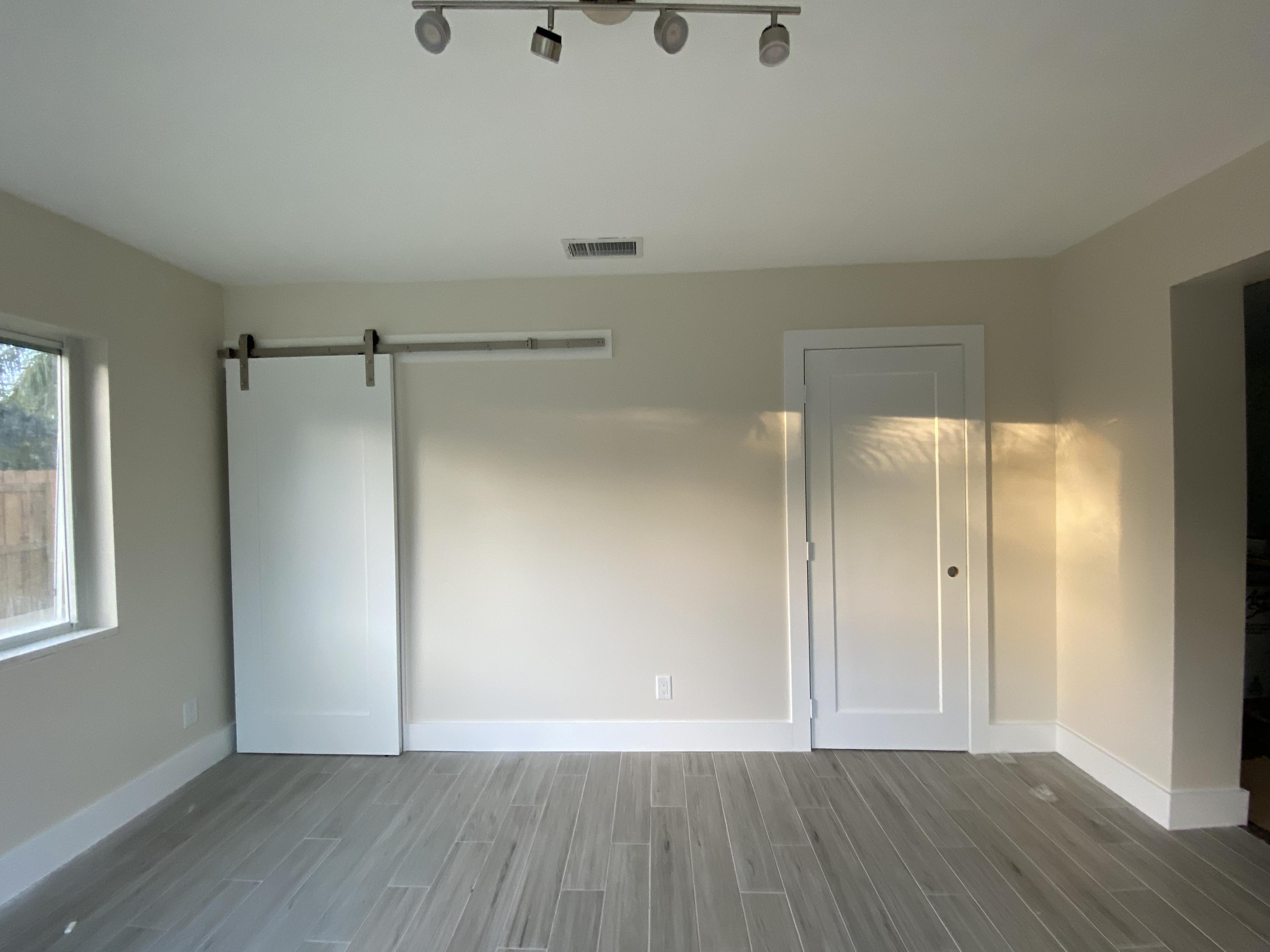 124 Northwest 9th Street Boca Raton, FL 33432 - Photo 3 of 18 a view of an empty room with wooden floor and a window
