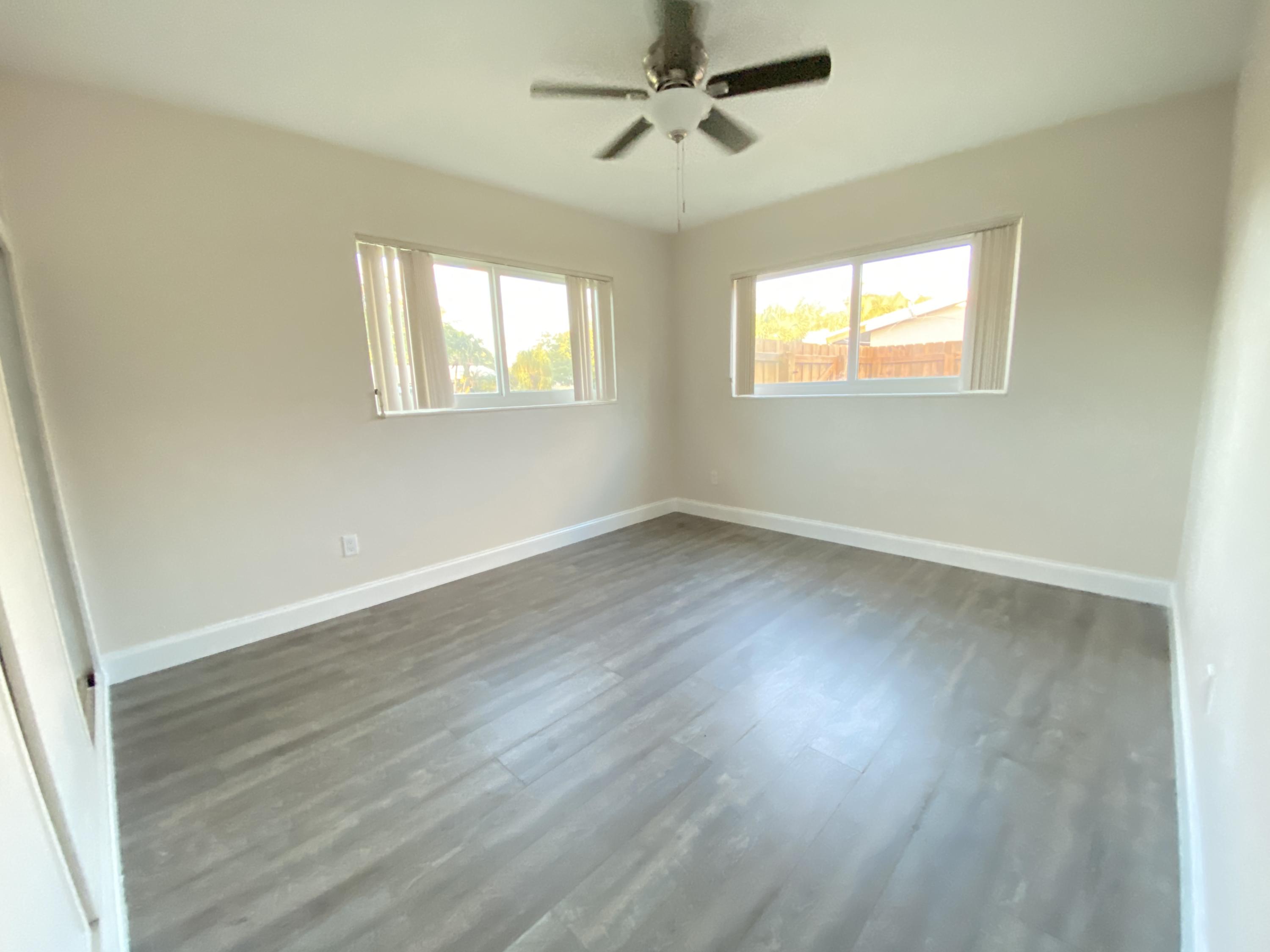 124 Northwest 9th Street Boca Raton, FL 33432 - Photo 6 of 18 a view of an empty room with wooden floor and a window