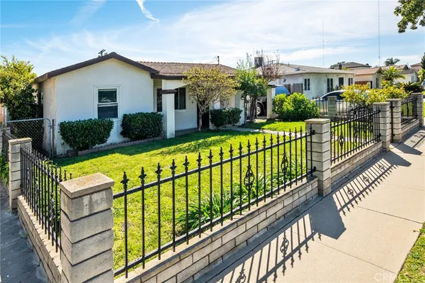 a view of a house with wooden fence