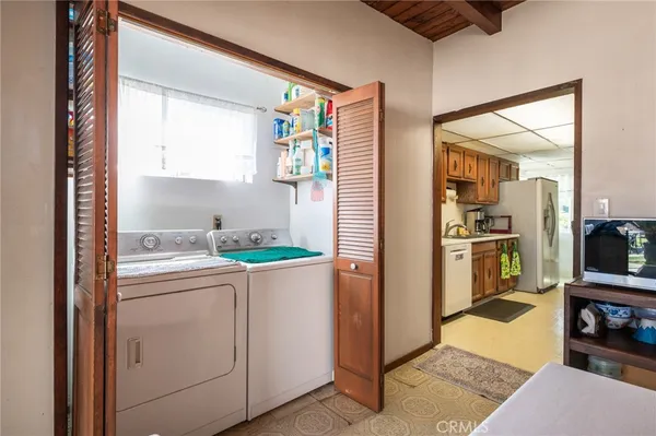 a bedroom with a bed and a flat tv screen on dresser