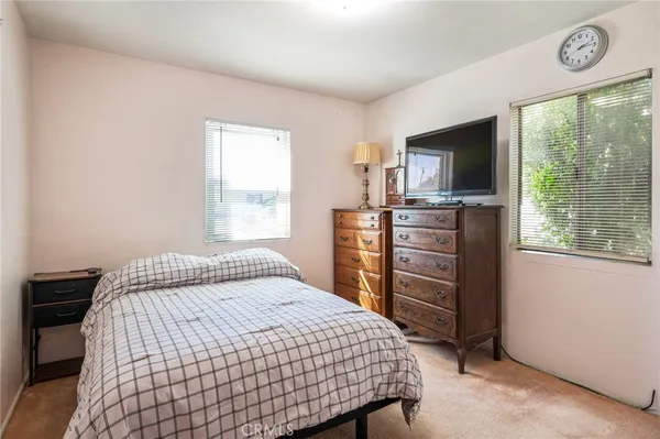 a bedroom with a bed and a cabinet