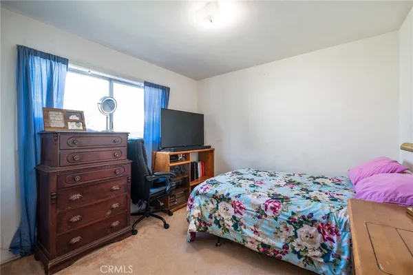 a view of a hallway with workspace and a window