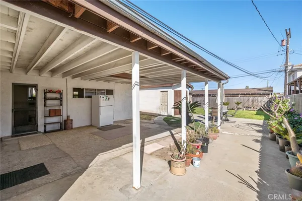 a view of a hallway with wooden floor and windows
