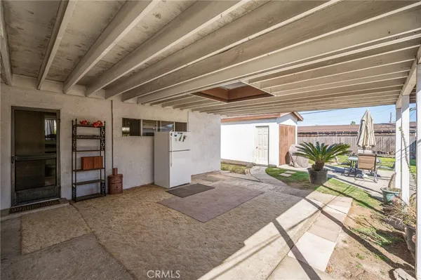 a view of backyard with outdoor seating and green space