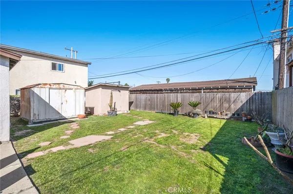 a view of a backyard with plants and outdoor seating