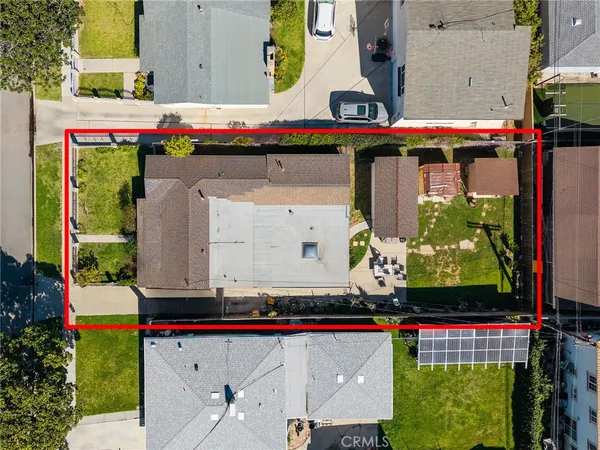 an aerial view of residential houses with outdoor space and swimming pool