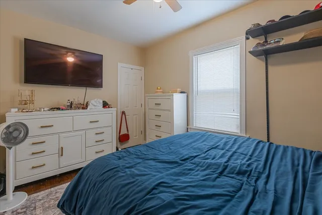 a bedroom with a bed and a flat screen tv