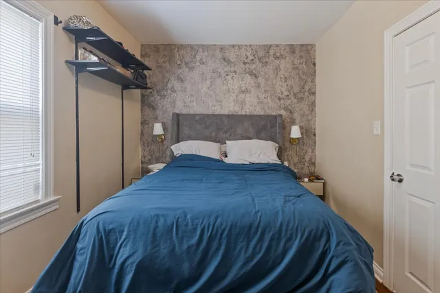 a bedroom with a bed and a window