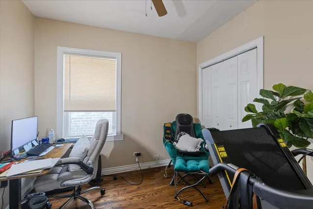 a view of a workspace with furniture and a window