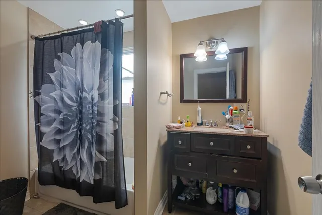 a bathroom with a sink vanity and a mirror